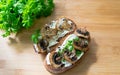 Two sandwiches with mushroom slices and curd cheese and fresh bright parsley. View from above. Healthy eating concept