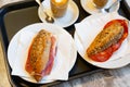 Sandwiches with chorizo and ham and cups of coffee Royalty Free Stock Photo