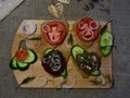 two sandwiches on a wooden Board rustic in the background blue flowers with Cutlery on the tablecloth. selective focus