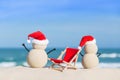 Two Sandy Christmas Snowmen are enjoying the beach Royalty Free Stock Photo