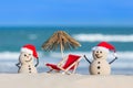 Two Sandy Christmas Snowmen are enjoying the beach Royalty Free Stock Photo