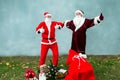 Two Santa Claus collect a big bag of gifts for Christmas. Royalty Free Stock Photo