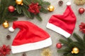 Two Santa Claus red hats and decoration on grey background. Christmas decoration Royalty Free Stock Photo