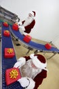 Two santa clauses working at production line