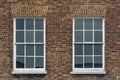 Two Sash Windows in Brick Wall Royalty Free Stock Photo
