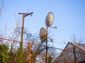 Two satellite dishes on a pole in the village. Antennas for TV Royalty Free Stock Photo