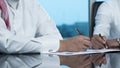 Two Saudi businessmen hands signing a document