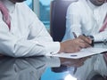 Two Saudi Businessmen Hands Signing A Ducument Royalty Free Stock Photo