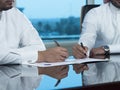 Two Saudi Businessmen Hands Signing A Ducument Royalty Free Stock Photo