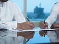 Two Saudi Businessmen Hands Signing A Ducument Royalty Free Stock Photo