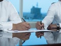 Two Saudi Businessmen Hands Signing A Ducument Royalty Free Stock Photo