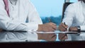 Two Saudi Businessmen Hands Signing A Ducument Royalty Free Stock Photo