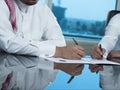 Two Saudi Businessmen Hands Signing A Ducument Royalty Free Stock Photo