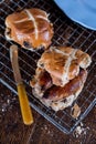 Two Sausage Cross Buns, Knife, and Plate on Wire Rack Royalty Free Stock Photo