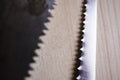 Two saws on a wood board table close up