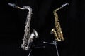 Two saxophones standing isolated in black Royalty Free Stock Photo