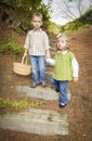 Two Scared Children Walking Down Wood Steps with Basket Outside.