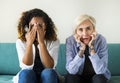 Two scared girls on the couch