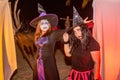 Two scary witches with face paint during Halloween party at the artificial cemetery on the beach