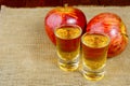 Two schnapps drinks and red apples