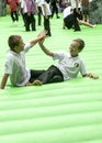 Two school children on an inflabable Stonehenge