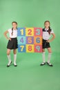 Two school girls hold color board with the number Royalty Free Stock Photo