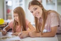 Two school girls writing during class Royalty Free Stock Photo