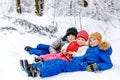 Two school kid boy and little toddler girl in winter forest. Happy children having fun with snow outdoors in winter Royalty Free Stock Photo