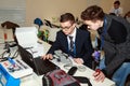 Two schoolboys programming the robot at robotics competitions.