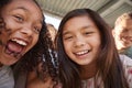 Two schoolgirls and friends smiling to camera, close up Royalty Free Stock Photo