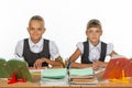 Two schoolgirls gaze intently and emotionlessly into the frame