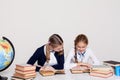 Two schoolgirls girls in class at her desk with books notebooks Royalty Free Stock Photo