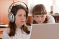 Two schoolgirls performs task using notebook Royalty Free Stock Photo