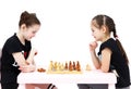 Two schoolgirls play chess on white background Royalty Free Stock Photo