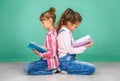 Two schoolgirls read books. The concept of childhood, learning
