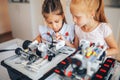 Two schoolgirls study in a robotics class, assemble a robot constructor Royalty Free Stock Photo