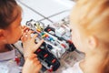 Two schoolgirls study in a robotics class, assemble a robot constructor Royalty Free Stock Photo