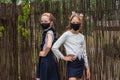 Two schoolgirls wearing masks and going back to school during covid-19 pandemic.Two schoolgirls wearing protective masks Royalty Free Stock Photo