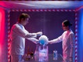 Two scientists experimenting in a containment tent