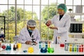 Two scientists research new chemical item in laboratory