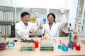 Two scientists are working in laboratory.Young female researcher and her senior supervisor are doing investigations on laboratory. Royalty Free Stock Photo