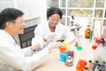 Two scientists are working in laboratory. Young female researcher and her senior supervisor are doing investigations on laboratory Royalty Free Stock Photo