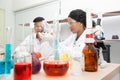 Two scientists are working in laboratory.Young female researcher and her senior supervisor are doing investigations on laboratory. Royalty Free Stock Photo