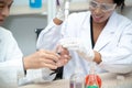 Two scientists are working in laboratory.Young female researcher and her senior supervisor are doing investigations on laboratory. Royalty Free Stock Photo