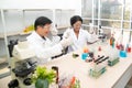 Two scientists are working in laboratory. Young female researcher and her senior supervisor are doing investigations on laboratory Royalty Free Stock Photo