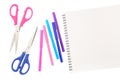 Two scissors, five felt tip pens in pink, blue and purple colors and blank sketchbook, isolated on white background. Space for tex Royalty Free Stock Photo