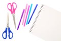 Two scissors, five felt tip pens in pink, blue and purple colors and blank sketchbook, isolated on white background. Space for tex Royalty Free Stock Photo