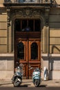 Two Scooters in front Vintage Wooden Door