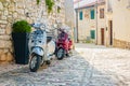 Two scooters leaning against a wall in Rovinj, Croatia Royalty Free Stock Photo