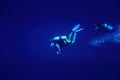 Two scuba divers swimming in deep blue Royalty Free Stock Photo